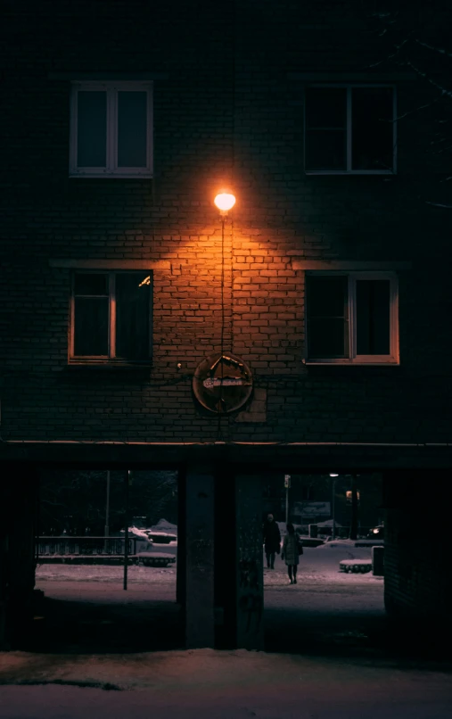 an illuminated bicycle leaning against a building at night