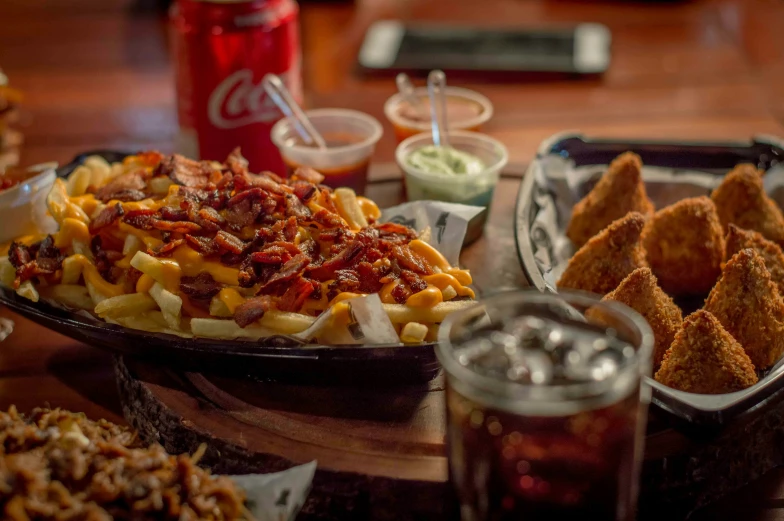 several different types of food on plates with dipping sauces and ketchup