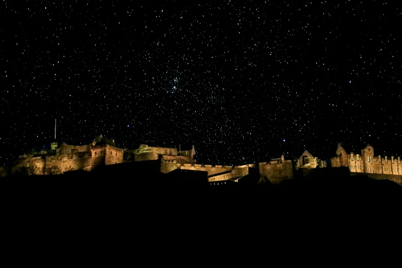 the castle sits in the nighttime sky with stars