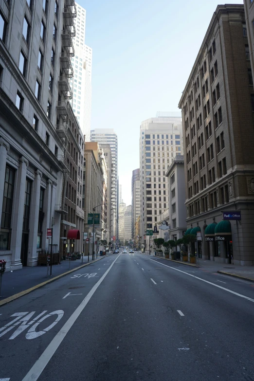 an empty street and few buildings on the other side