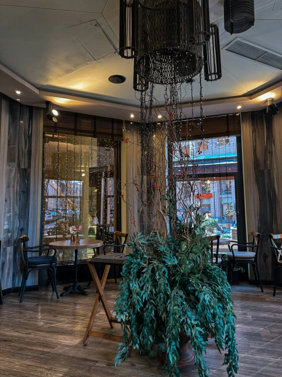 a dining room with large chandelier hanging from the ceiling