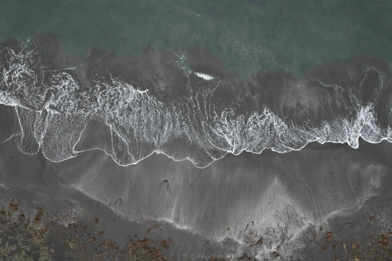 an aerial view of the ocean waves and water