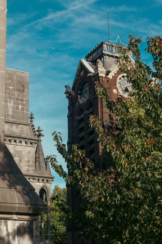 an old church with tall tower and clock on it's face