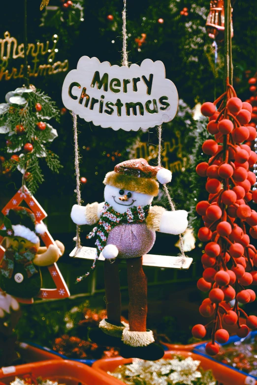 a christmas display with two stuffed bears hanging from strings