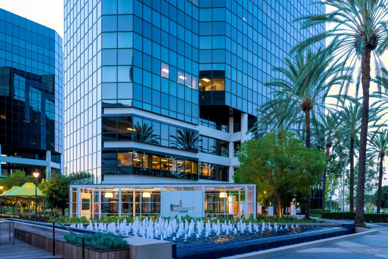 an office building with a fountain in front