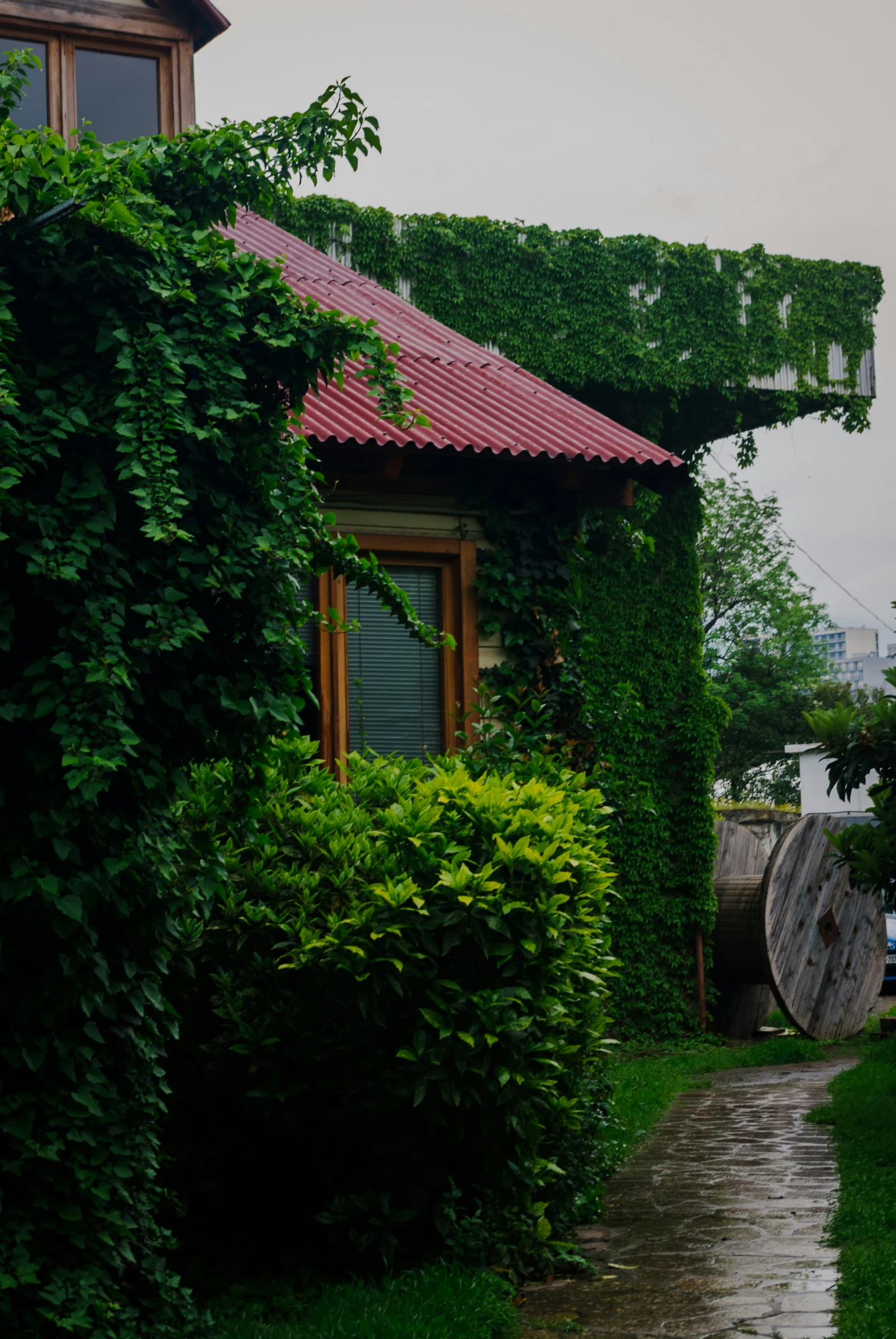 a red roofed house that is sitting on some bricks