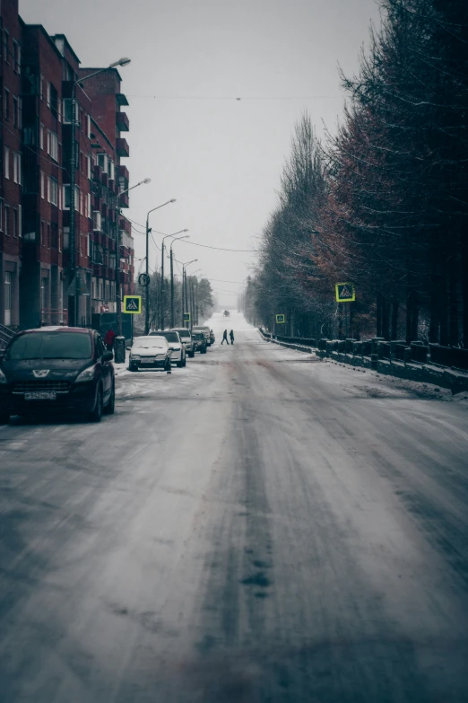 a street filled with cars on top of snow covered roads