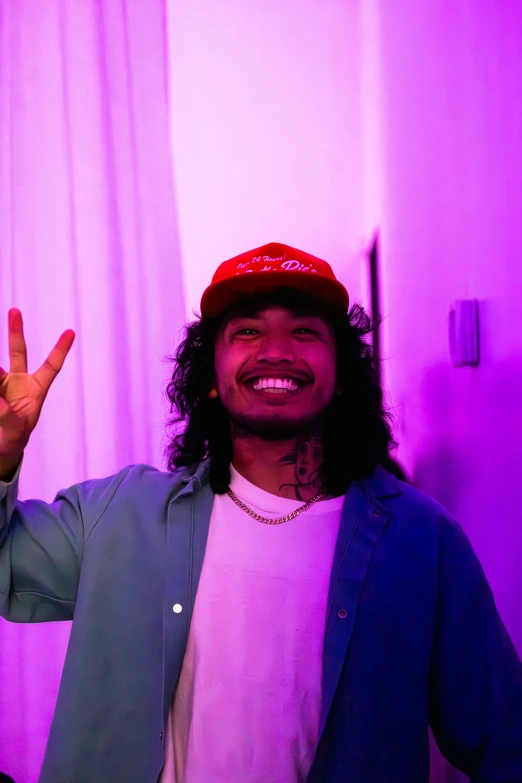 young man in green and red shirt with peace sign