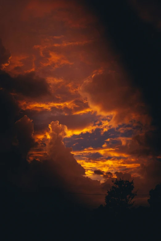 a lone airplane is silhouetted against a sky with dark clouds