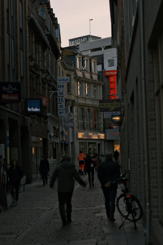 people are walking in the street near some building