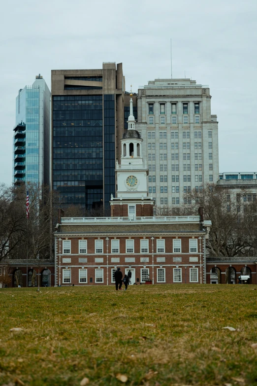 tall building with a steeple and two towers near by