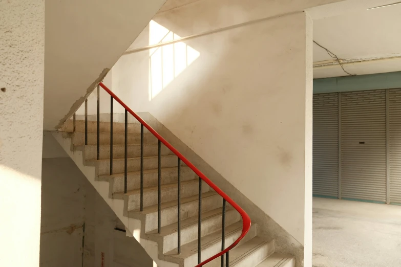 a white room with a staircase inside of it