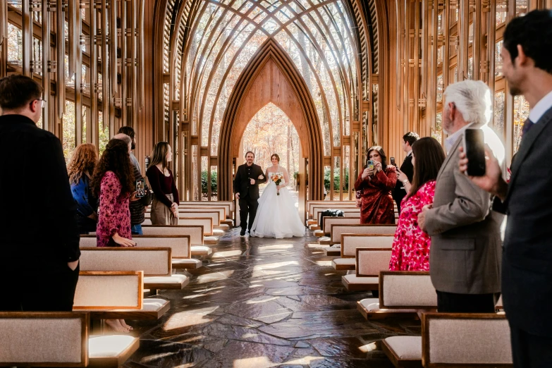 a bride and groom walk down the aisle together