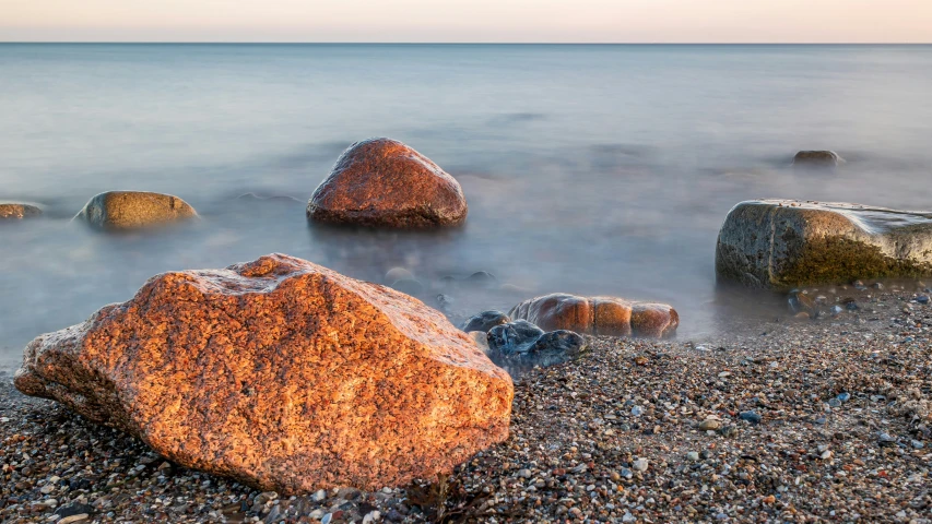 several rocks that have turned on in the water