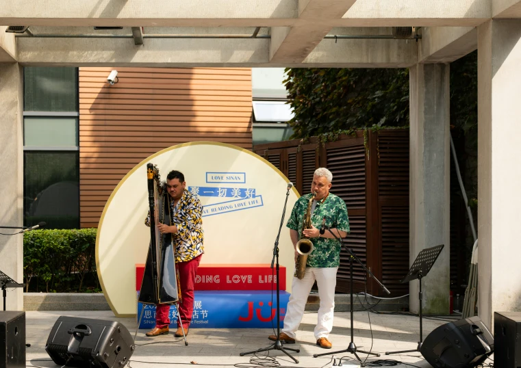 two men playing instruments with another person looking on