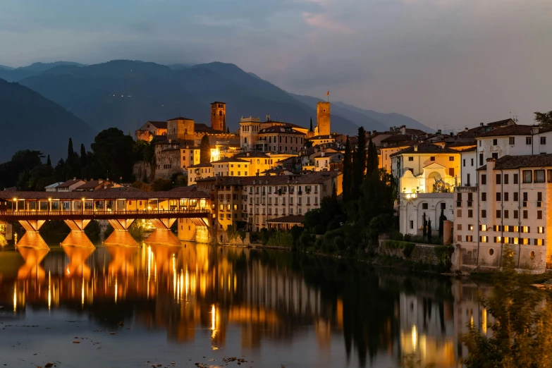 the lights of several buildings stand on the waters edge