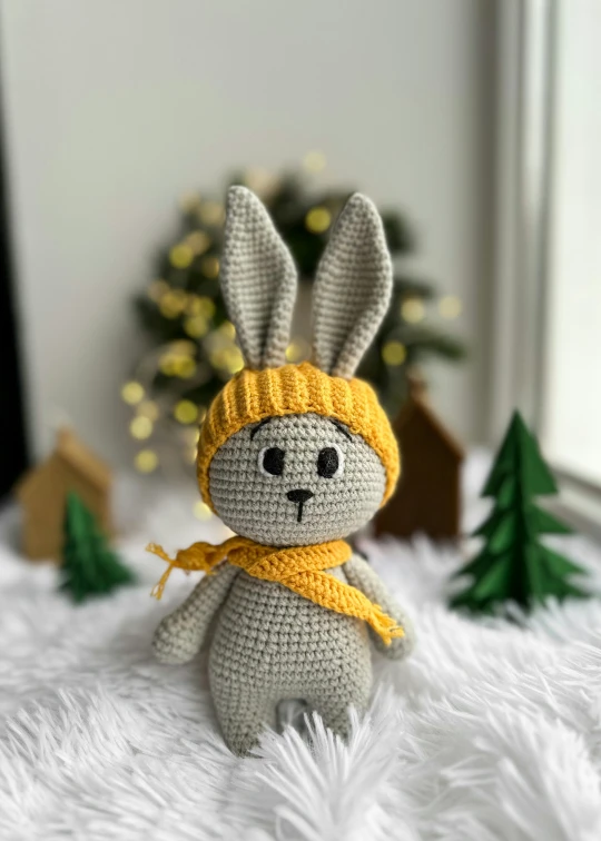 crochet stuffed rabbit wearing a yellow scarf and hat