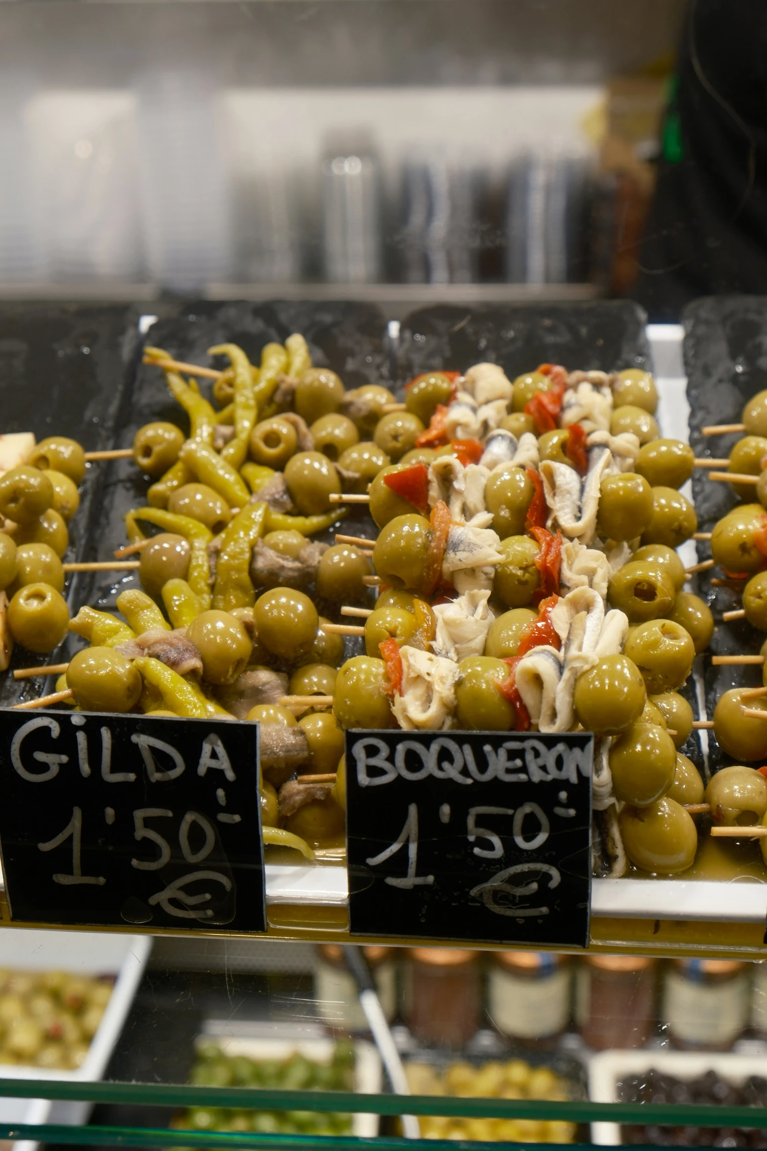 various types of olives for sale in a store