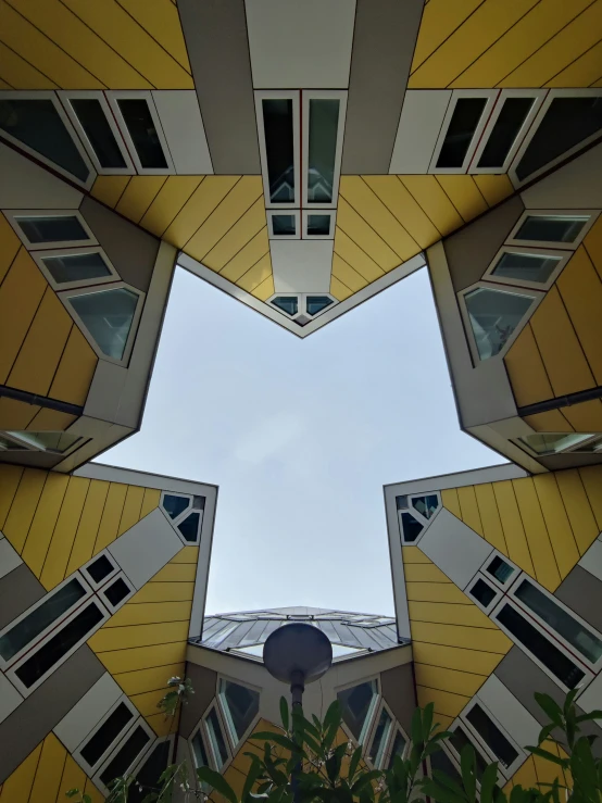 an odd building with various windows under the sky