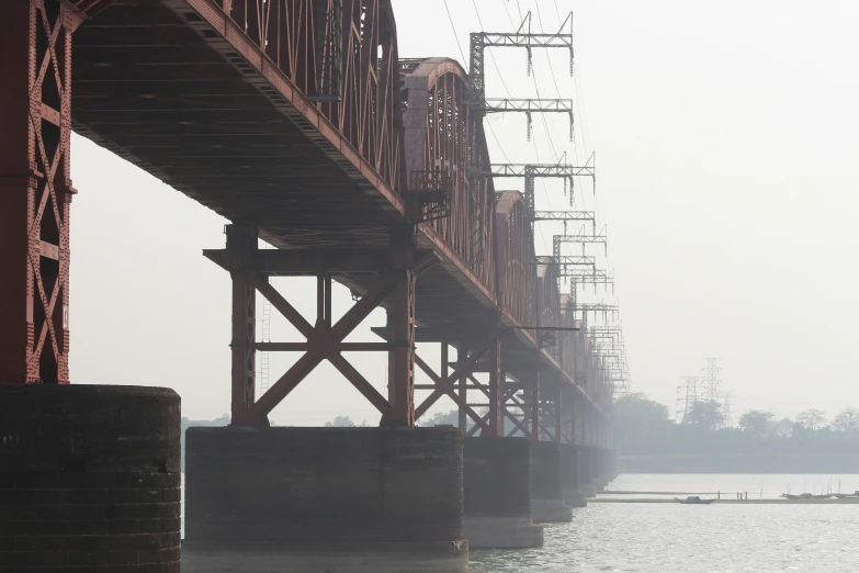 the large bridge is under a very hazy sky