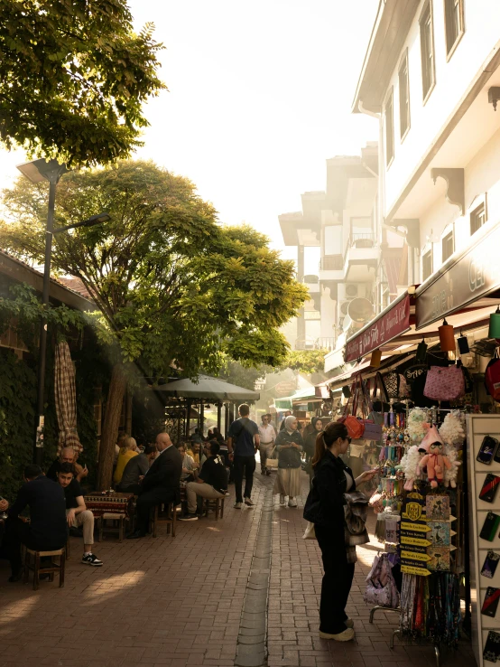 a number of people on a brick sidewalk near a building