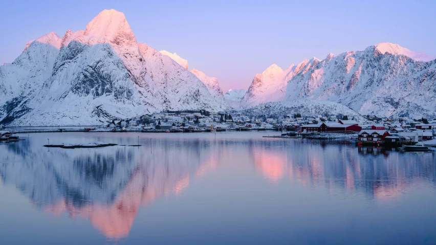 a harbor and a large mountain range in the background