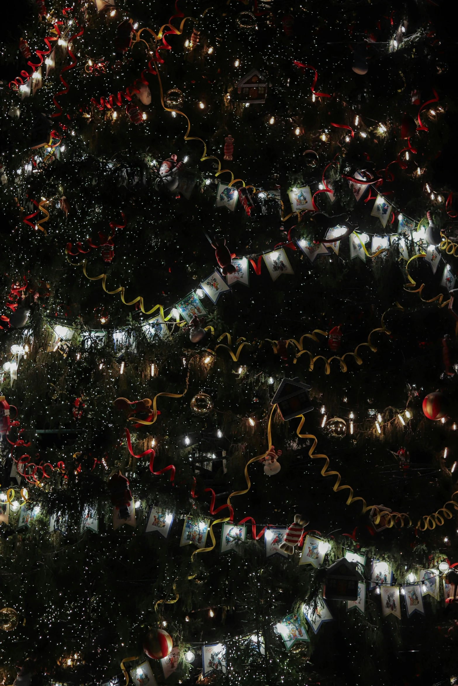 large christmas tree lit up with lots of different colored lights