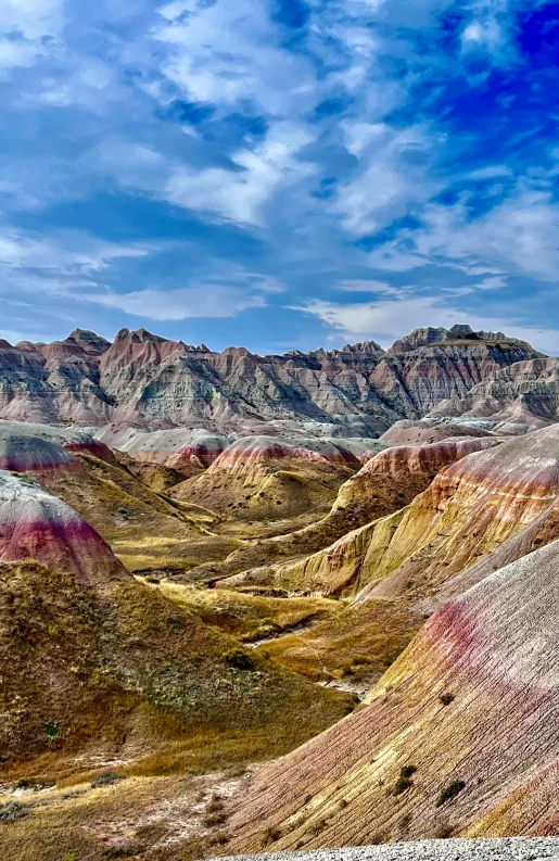 colorful hills in the rocky desert under a cloudy sky