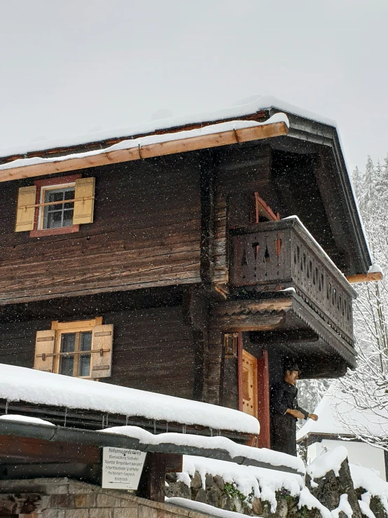 a house on top of a mountain during a winter day