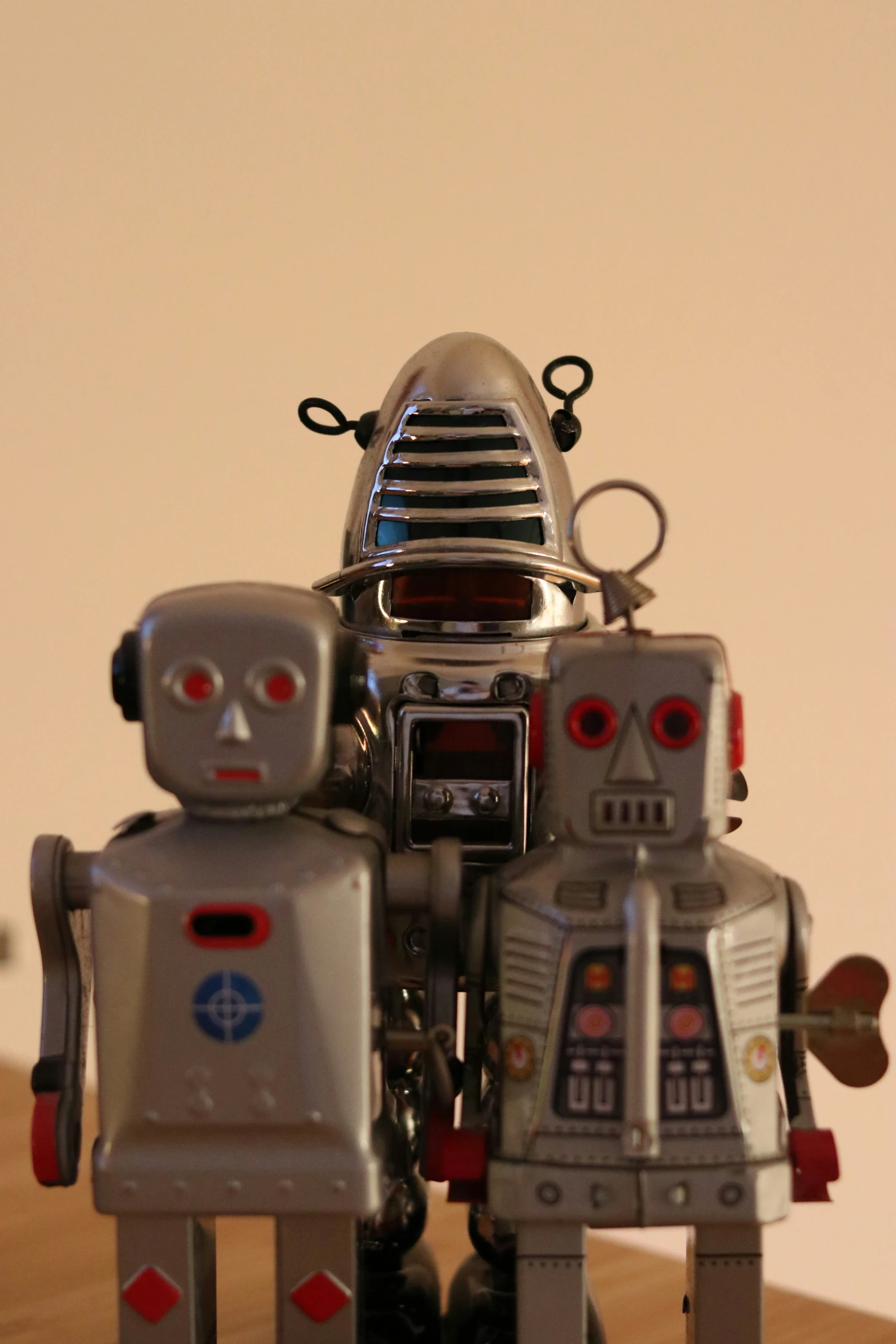 a toy robot is standing next to another robot