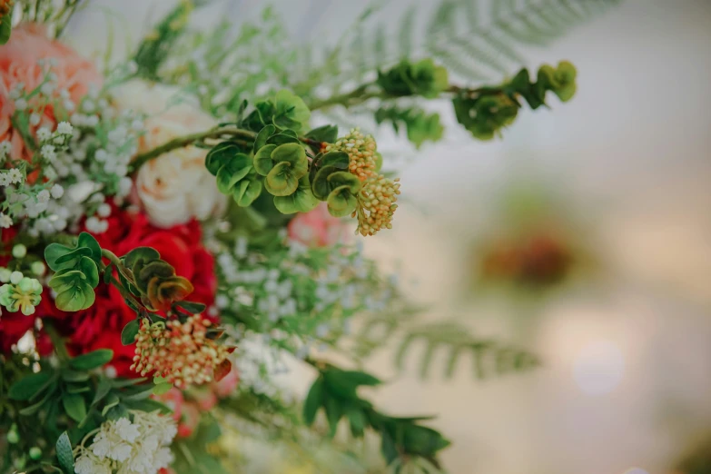 a flower bouquet in bright colors and green leaves