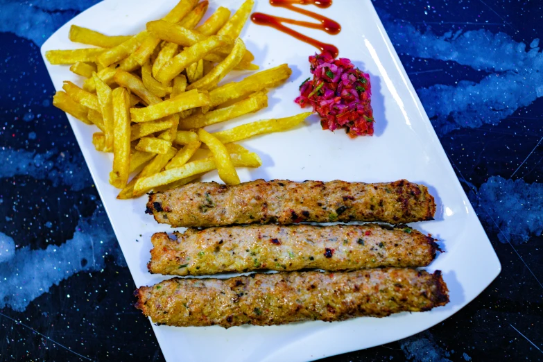 a white plate topped with fried food on top of a table