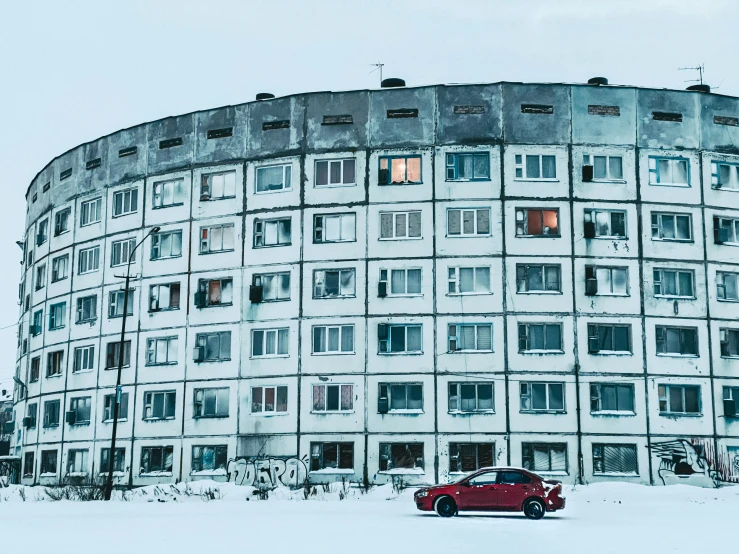 a car parked in front of a building during winter