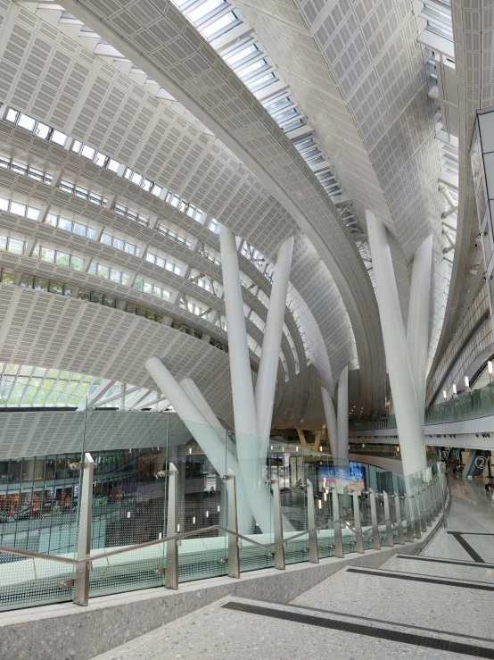 an airport filled with people and metal and glass walkways