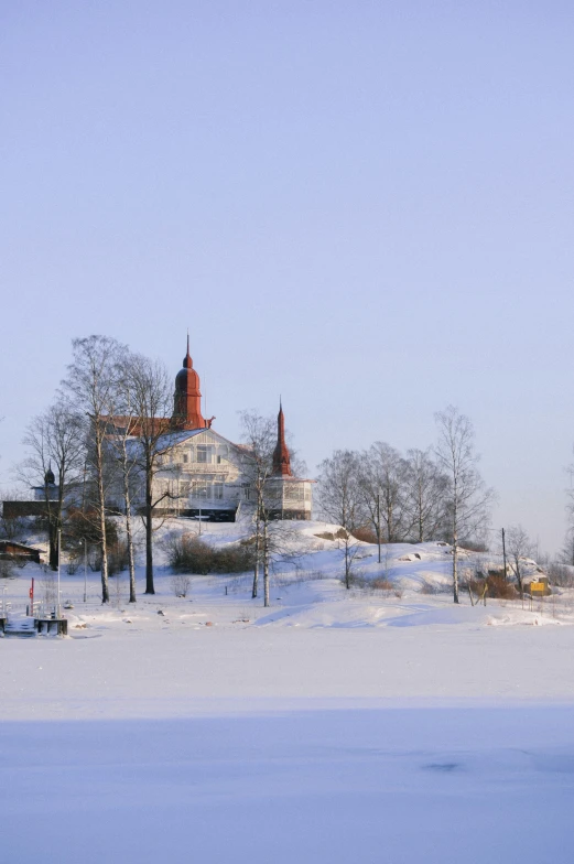 winter landscape with houses in distance and trees