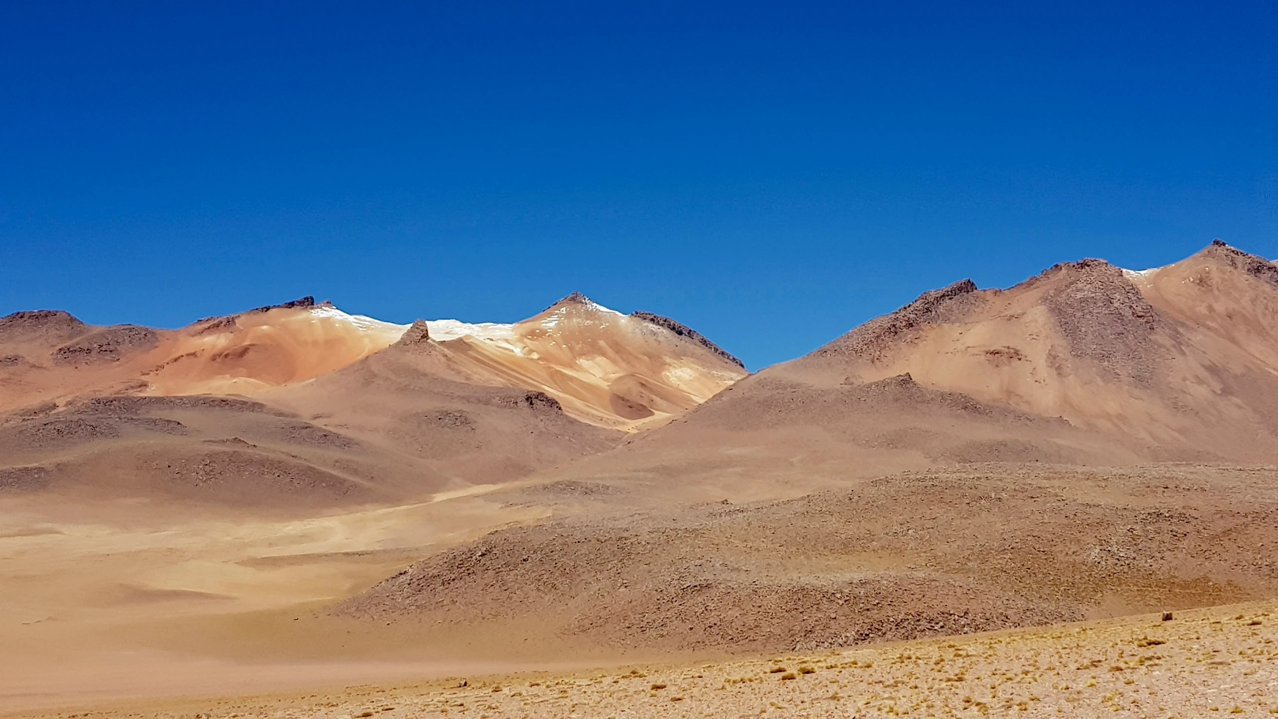 a group of mountains in a desert like setting