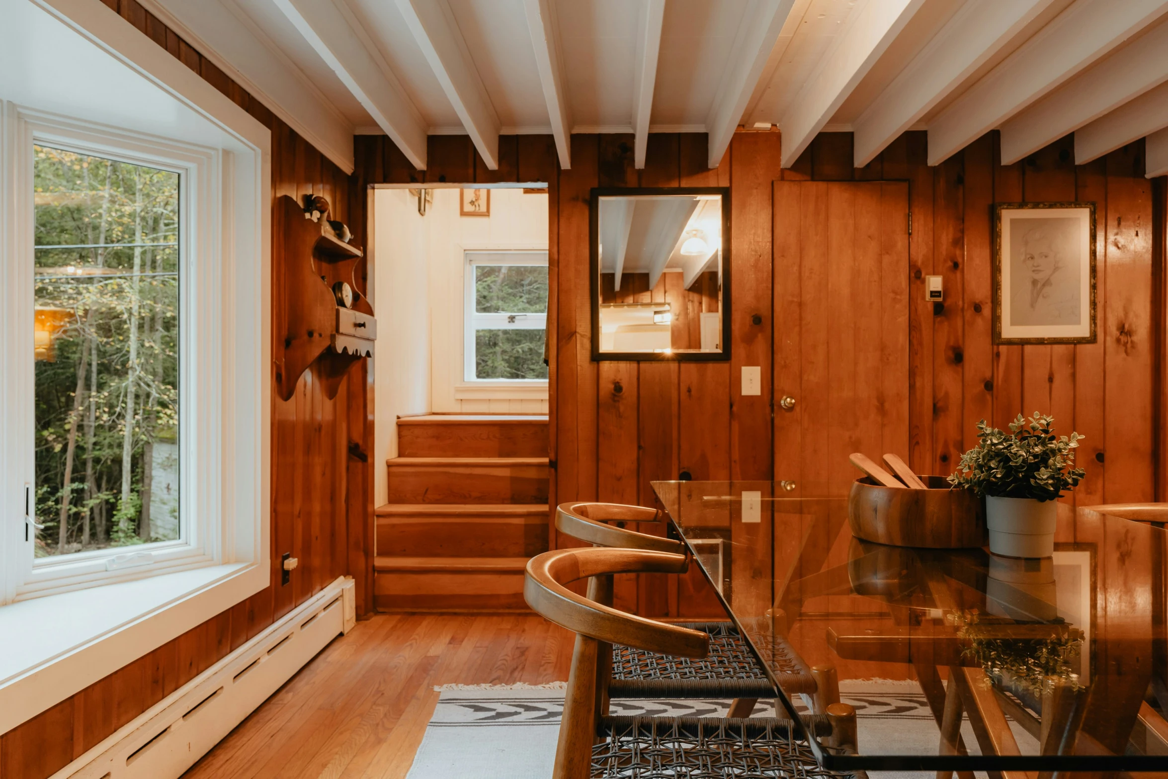 the view from inside of a house shows a dining room table and chairs