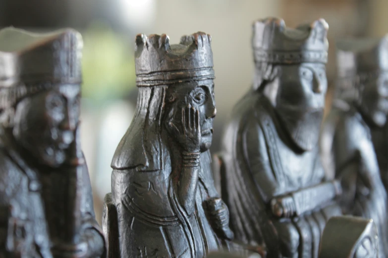 a group of small carved wooden sculptures of people