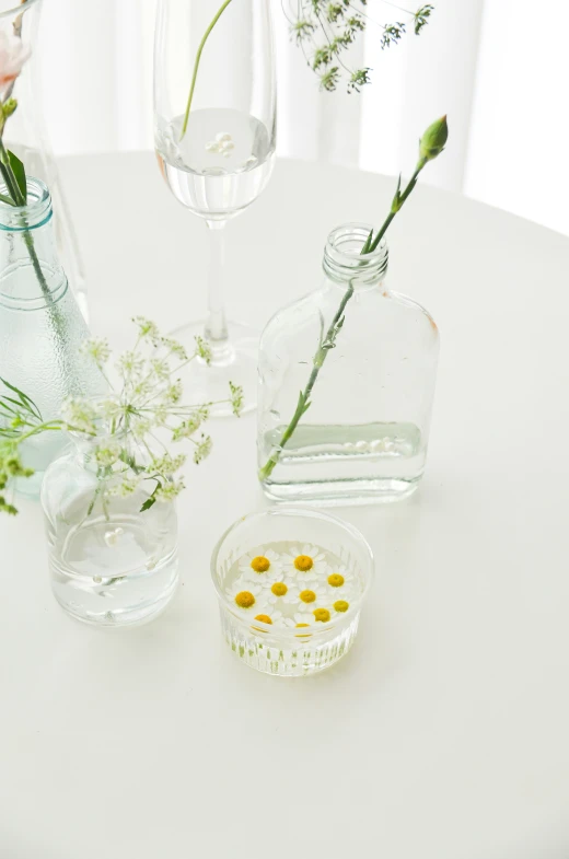 flowers and vases of various sizes are on the table