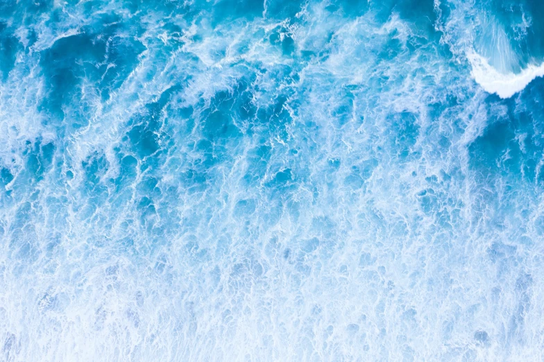 people walking and riding surfboards near a crashing wave