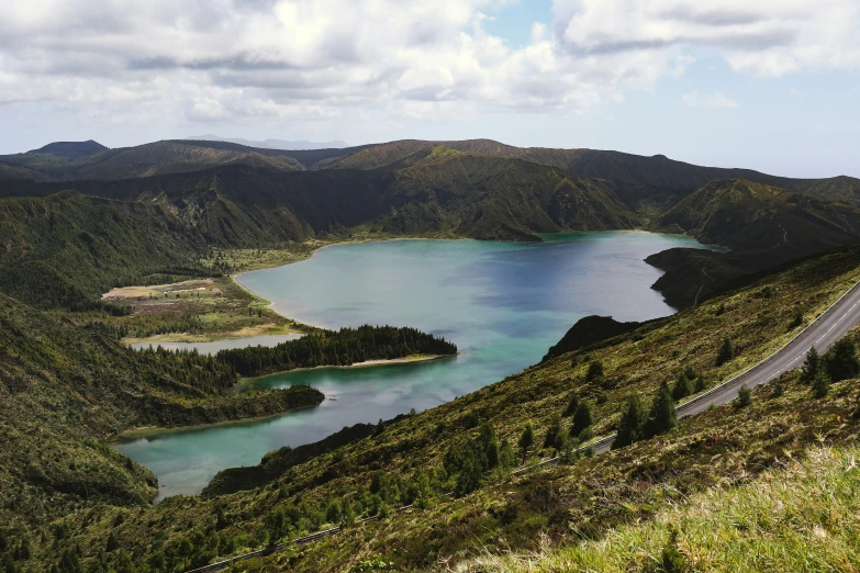 a road curves next to a body of water