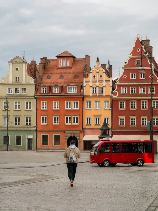 the building on the street is colorful and has red and yellow paint