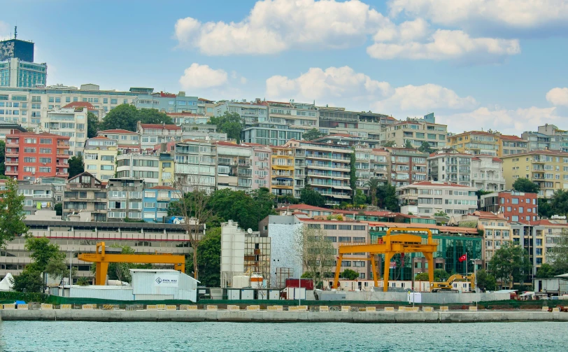 the view from across the lake shows many buildings on each hill