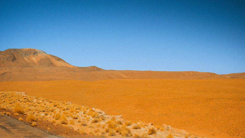 an airplane is flying over a very desert landscape