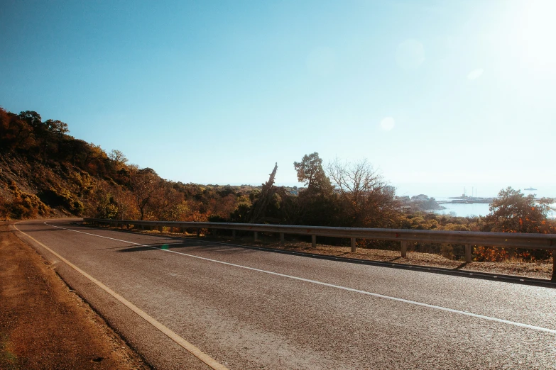 the empty road is near a steep hill