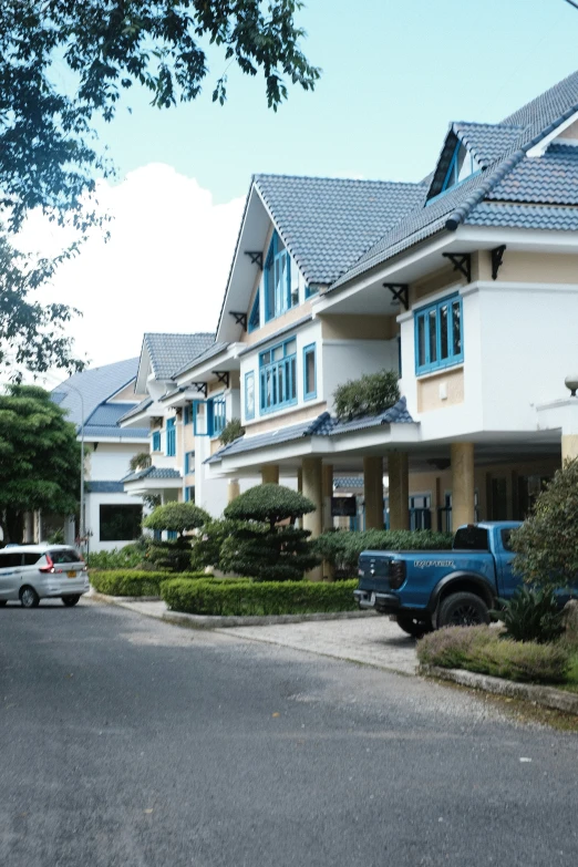 the white houses have many windows and blue shutters