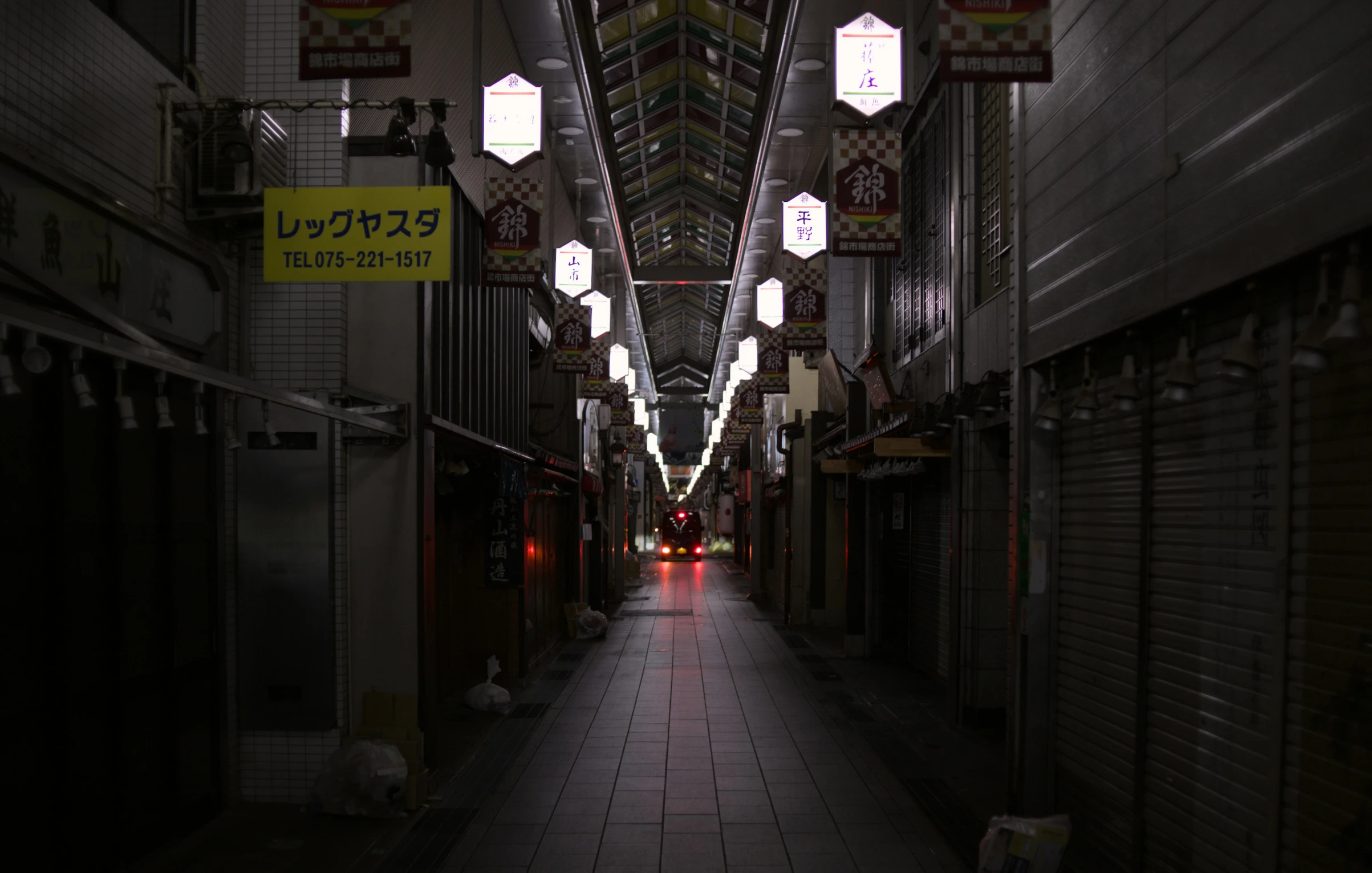 a long narrow city street with lights on either side