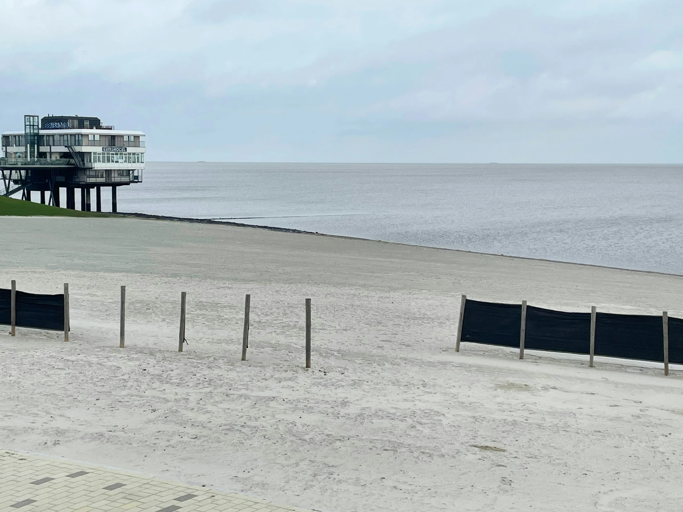 a small house with a balcony overlooking the ocean