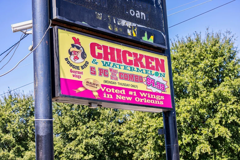 the sign outside a chicken restaurant that has a very bright color