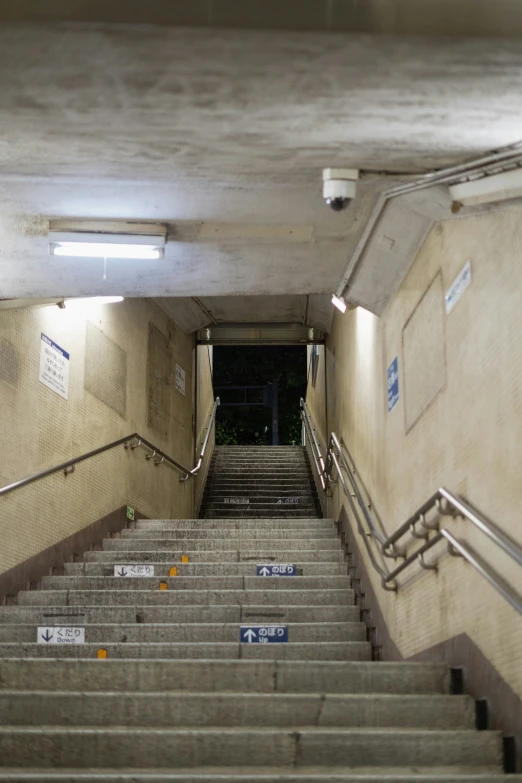 an empty staircase with signs on them next to some stairs